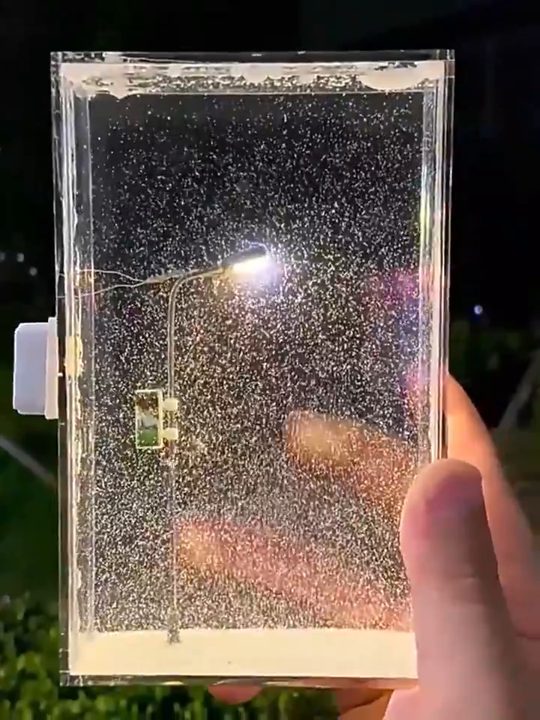 The finished light glowing in a hand at night